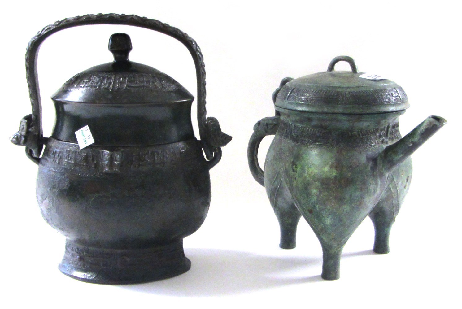 Appraisal: A Chinese replica bronze covered wine vessel and a spouted