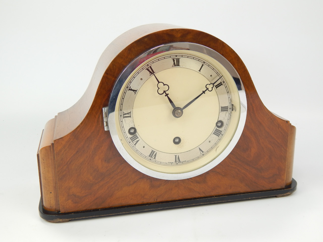 Appraisal: A walnut cased mantel clock with silvered chapter ring a