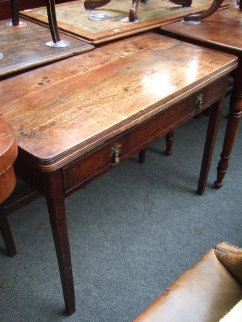 Appraisal: A George III oak fold-over tea table the D shaped