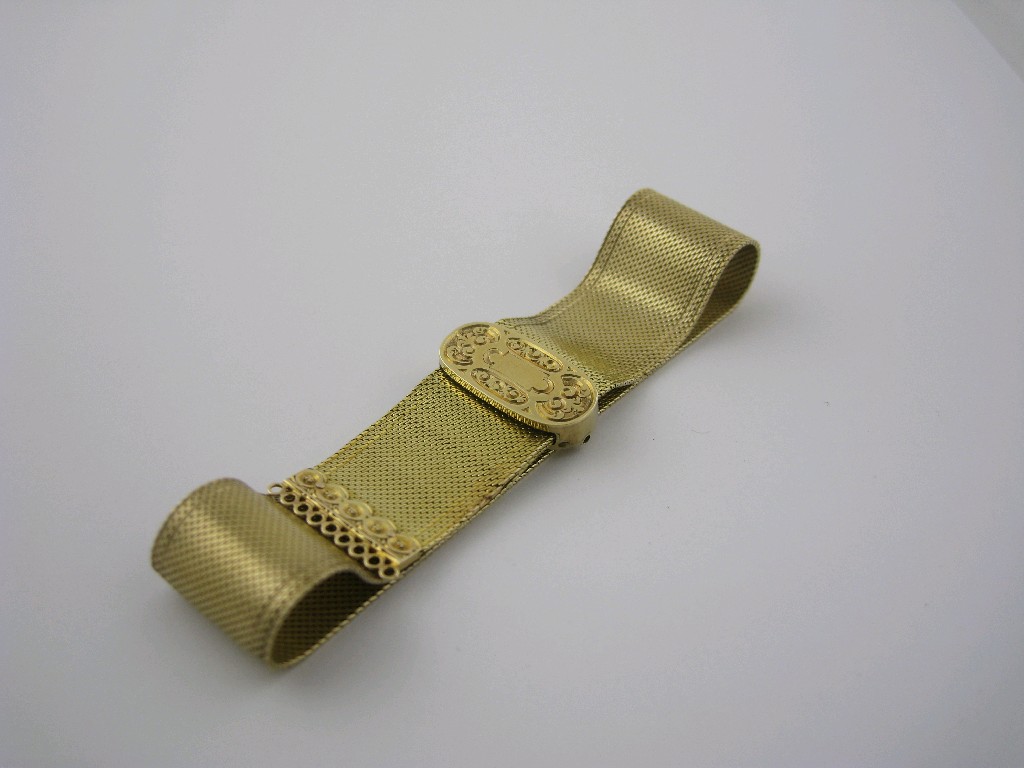 Appraisal: A finely woven gold Ribbon Bracelet with scroll engraved sliding