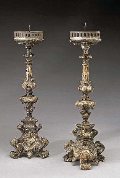 Appraisal: A pair of Italian Baroque silvered giltwood pricket candlesticks Tuscany