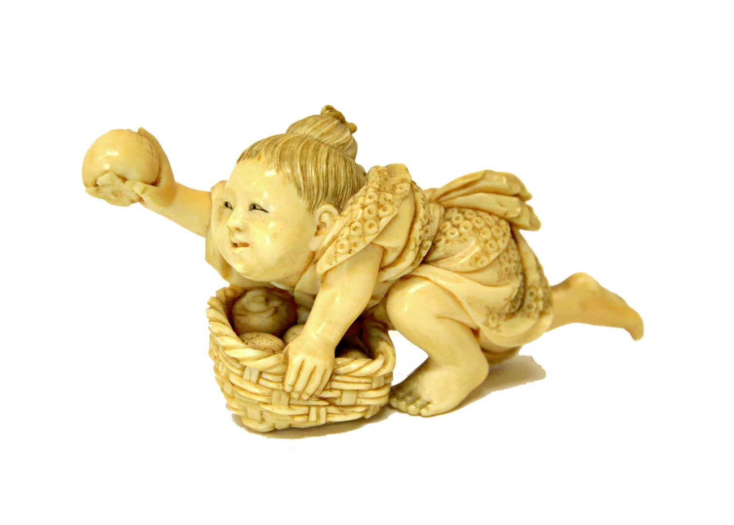 Appraisal: A Japanese ivory netsuke of a child Meiji period crouching