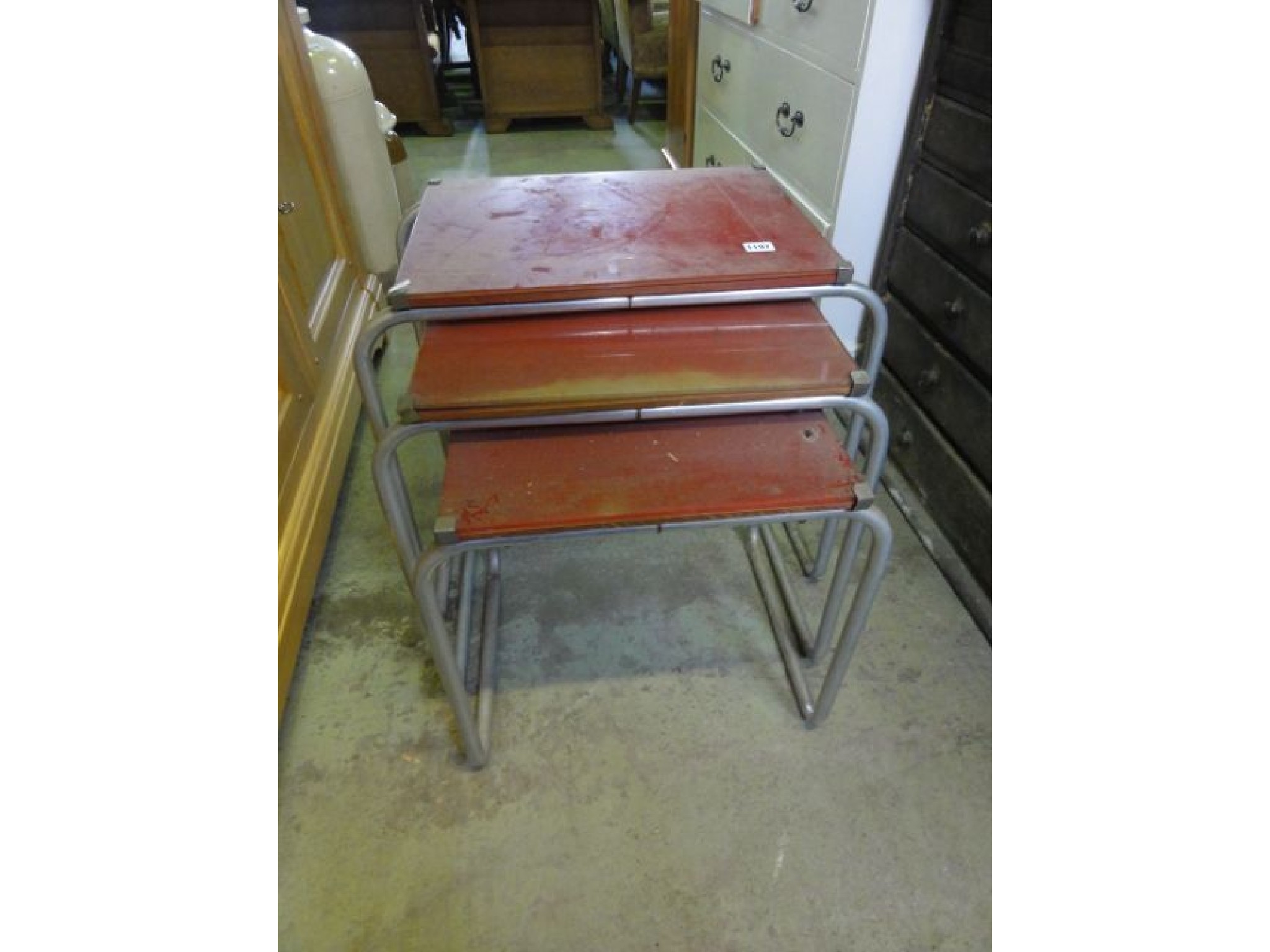 Appraisal: A nest of three graduated occasional tables the rectangular red