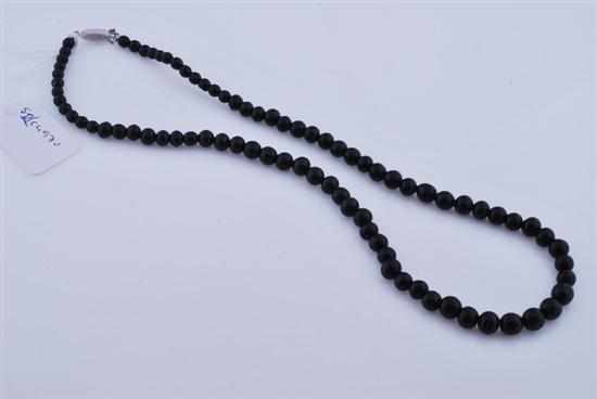 Appraisal: AN ONYX BEAD NECKLACE WITH STERLING SILVER CLASP