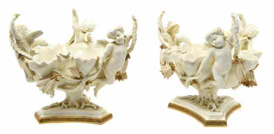 Appraisal: A Pair of Moore Porcelain Compotes having winged putti issuing