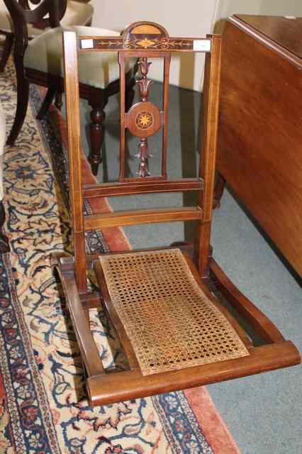 Appraisal: AN EDWARDIAN MAHOGANY AND SATINWOOD INLAID FOLDING CHAIR with cane