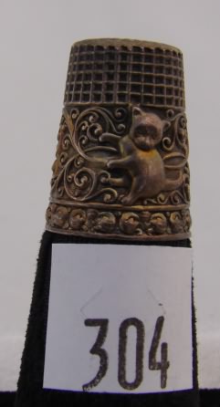 Appraisal: Thimble with kitten and scroll design