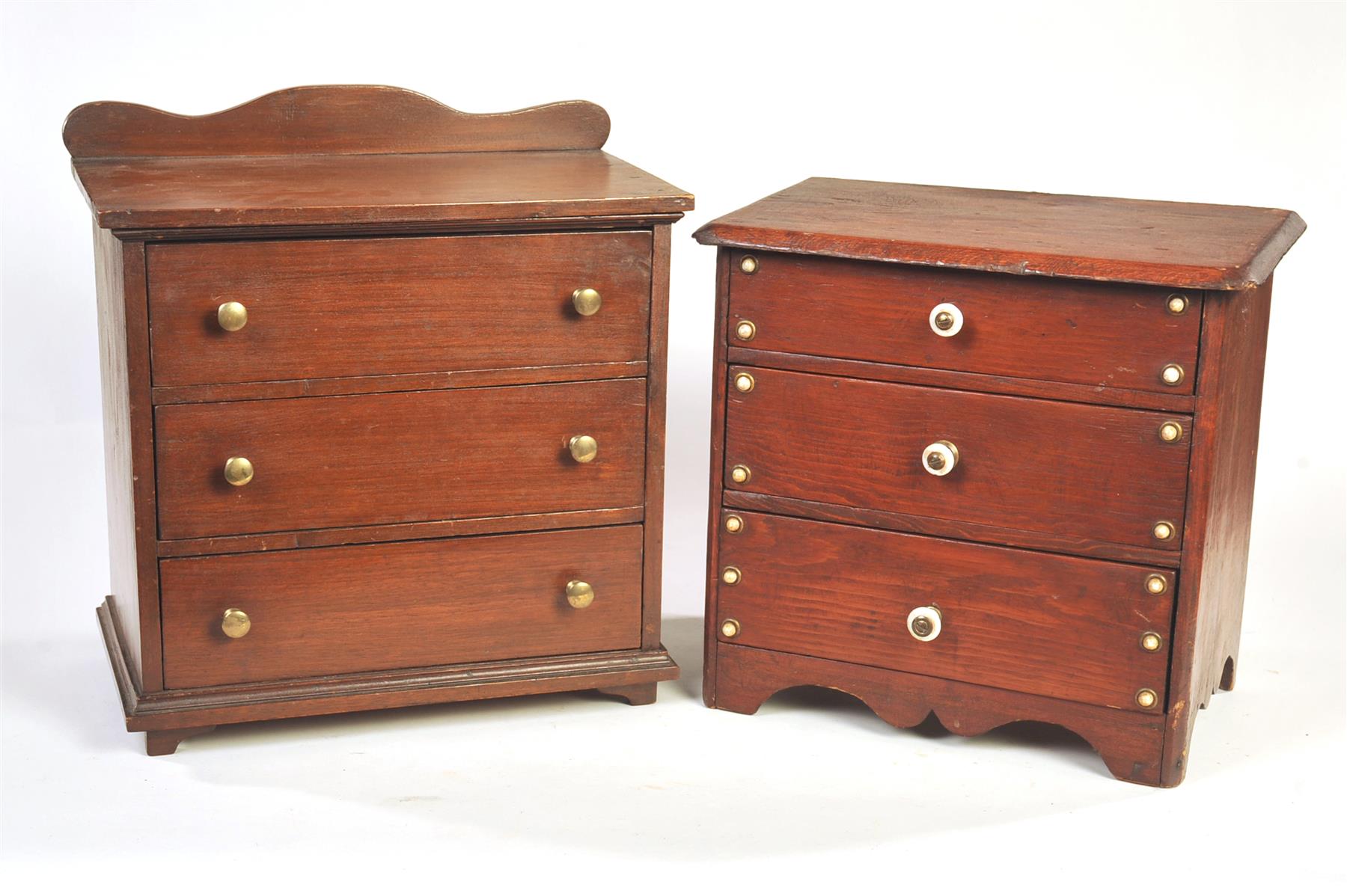 Appraisal: TWO MINIATURE THREE-DRAWER CHESTS American ca Walnut with scalloped backsplash