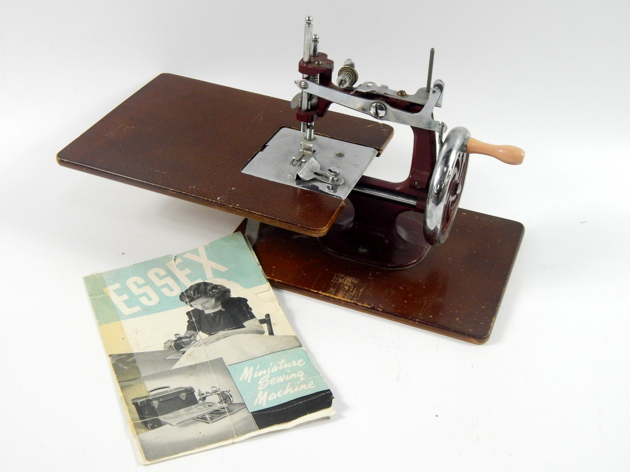 Appraisal: An Essex miniature sewing machine with instructions and two spinning