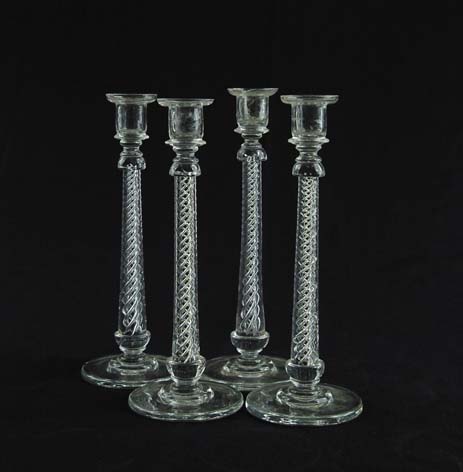 Appraisal: FOUR CONTROLLED BUBBLE CANDLESTICKS Four matching candlesticks feature swirling controlled