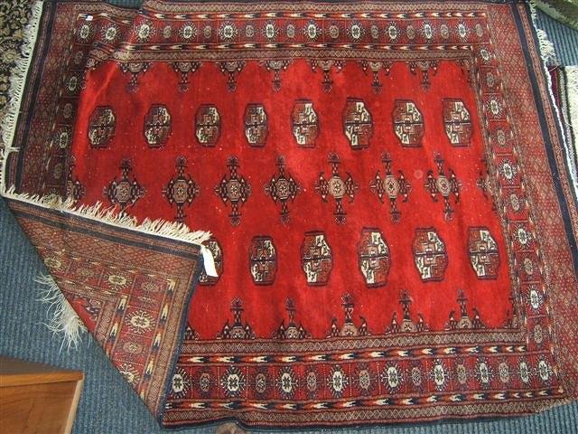 Appraisal: A red ground rug with banded border x