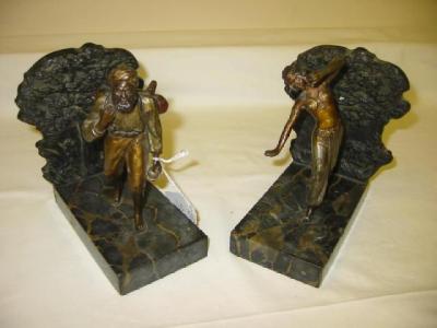 Appraisal: A PAIR OF BRONZE FIGURAL BOOKENDS modelled as an eastern