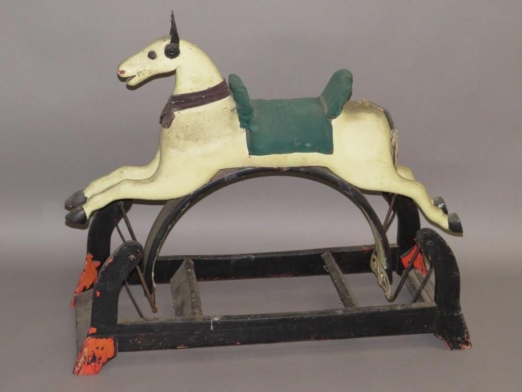 Appraisal: ROCKING HORSEca painted wood horse with leather ears on iron