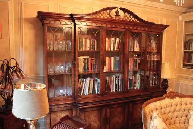 Appraisal: A GEORGE III STYLE MAHOGANY BREAKFRONT LIBRARY BOOKCASE with pierced