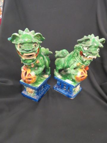 Appraisal: Pair of Chinese Pottery Foo Dog Figurines polychrome finish tall