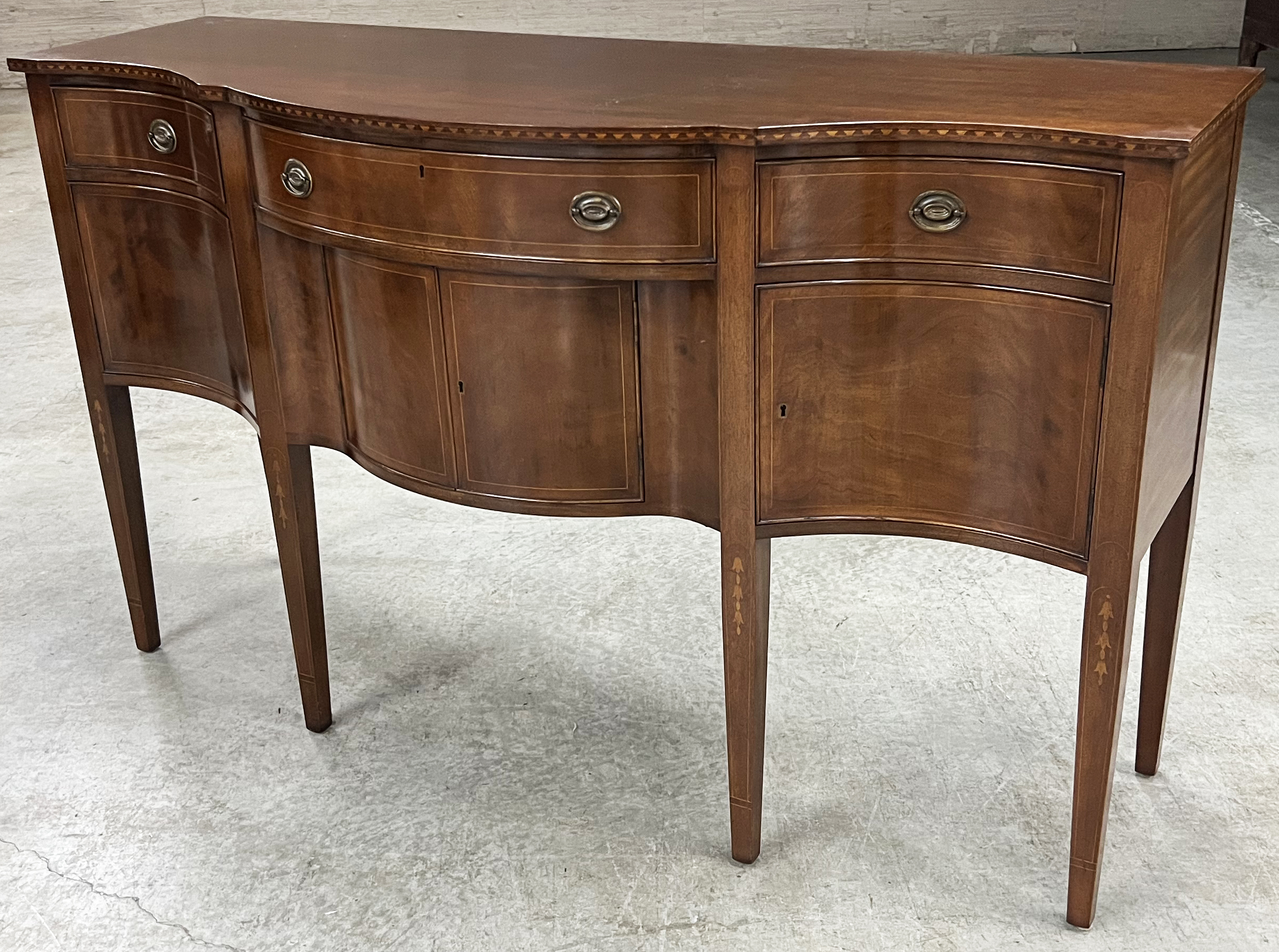 Appraisal: AMERICAN MAHOGANY SERPENTINE SIDEBOARD American mahogany serpentine sideboard Sheraton style