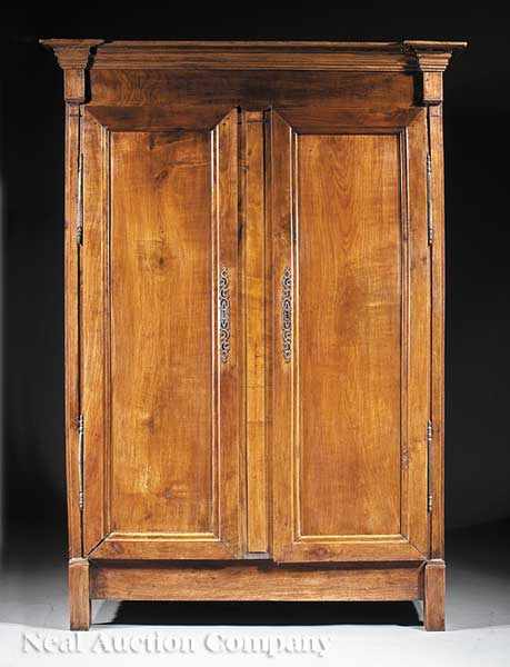 Appraisal: A French Provincial Restauration Carved Fruitwood Armoire c stepped cornice