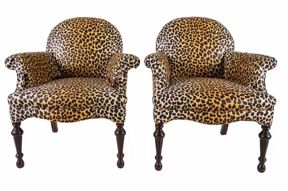 Appraisal: PAIR OF CLOSED ARMCHAIRSwith cheetah print fabric on carved wood