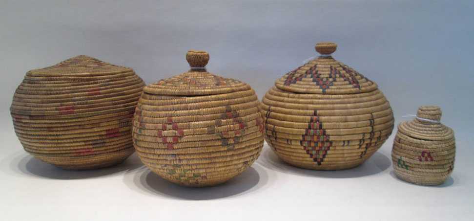 Appraisal: FOUR ESKIMO LIDDED BASKETS of coil construction with multi-colored geometric