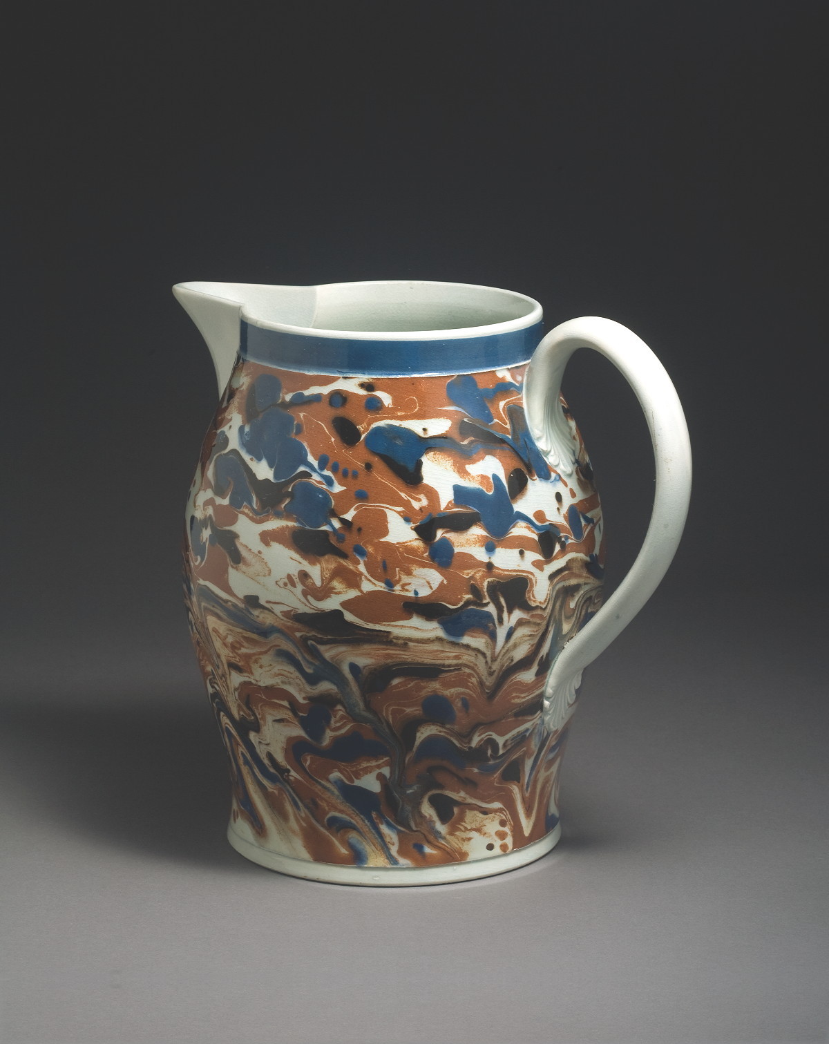 Appraisal: BRITISH PEARLWARE MOCHAWARE JUG CIRCA Of ovoid form slip-marbled in