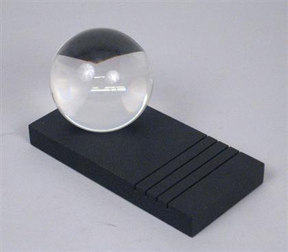 Appraisal: ATTRIBUTED TO STEUBEN Solid crystal ball on black plinth base