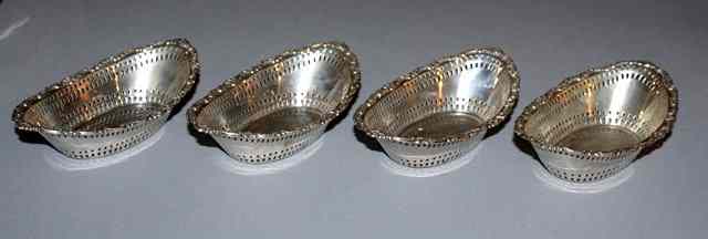 Appraisal: A SET OF FOUR VICTORIAN OVAL SWEETMEAT DISHES with pierced