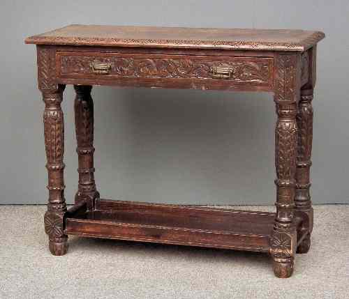 Appraisal: A Victorian carved oak rectangular side table carved throughout with