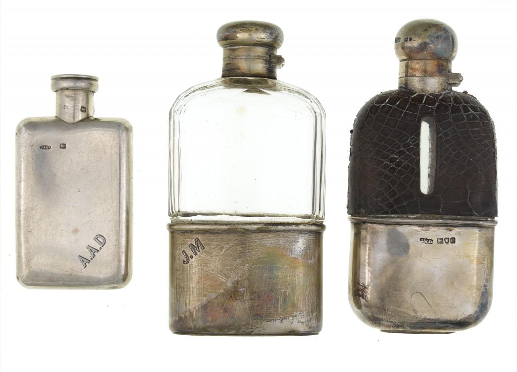 Appraisal: A VICTORIAN SILVER HIP FLASK AND TWO SILVER MOUNTED GLASS