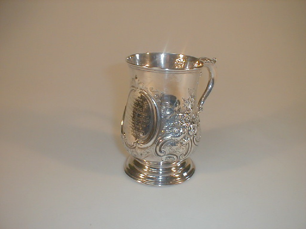 Appraisal: A Victorian silver tankard of baluster form repouse with flowers