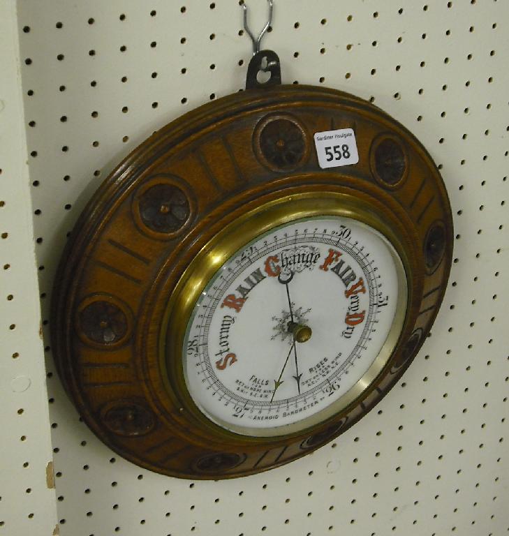 Appraisal: Oak cased circular aneroid barometer the white dial within a