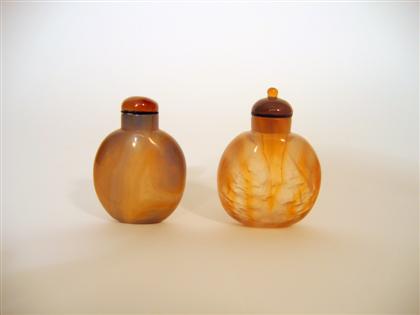 Appraisal: Two Chinese 'smoky' agate snuff bottles Both of fat ovoid