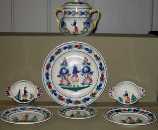 Appraisal: FRENCH QUIMPER FAYENCE DINNER SERVICE Polychrome painted with figure of