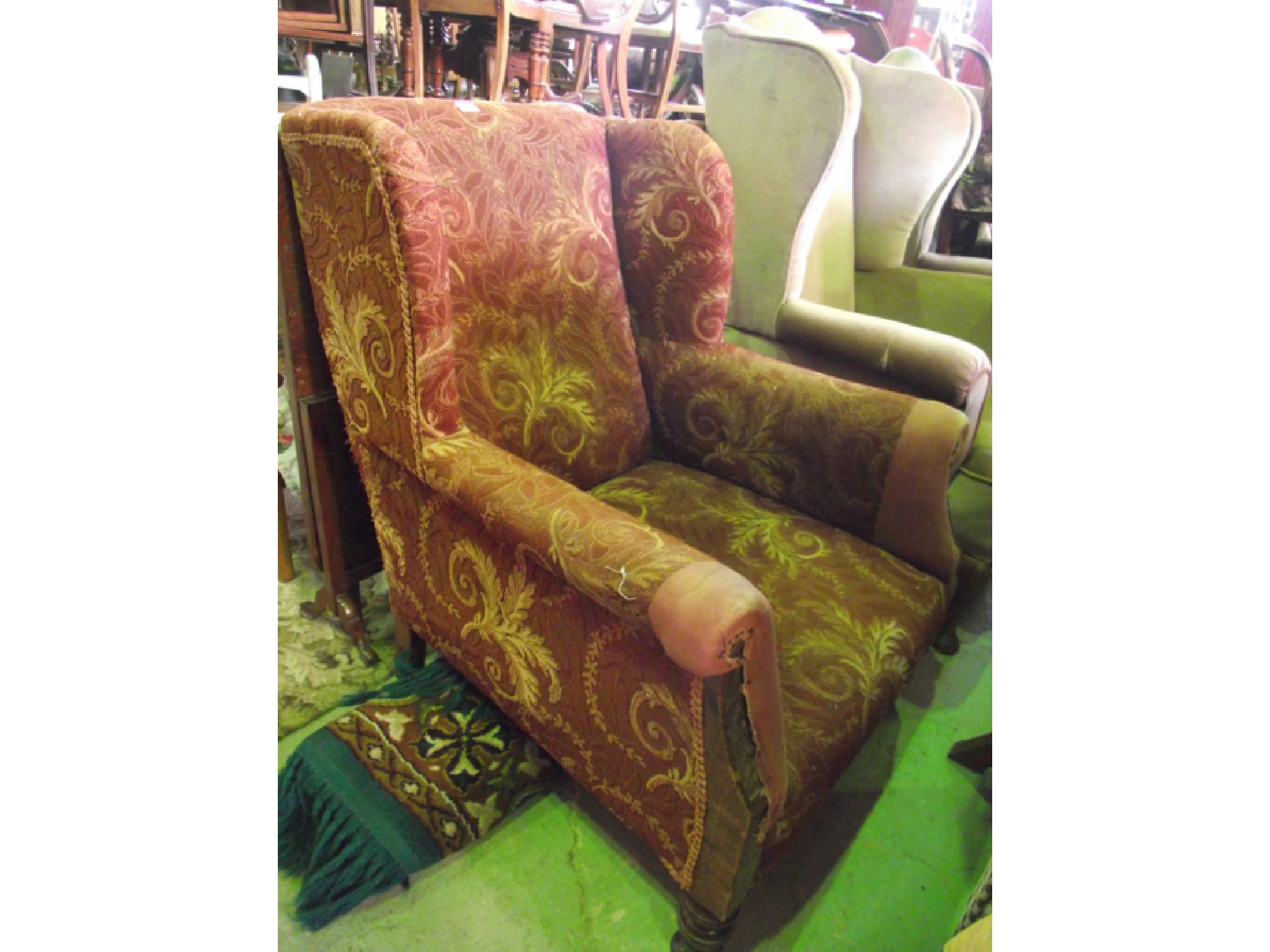 Appraisal: An Edwardian wing chair with upholstered finish and carved forelegs