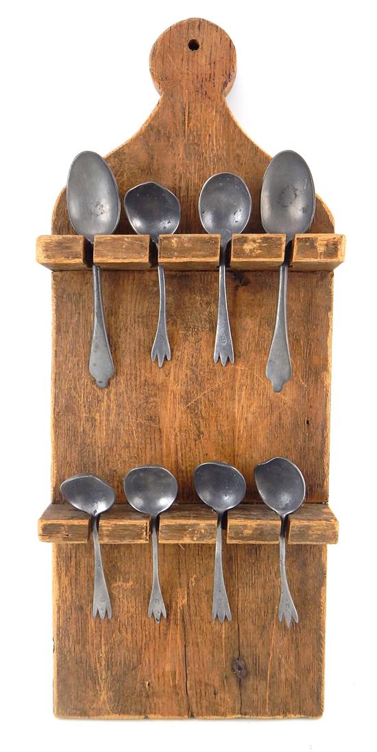 Appraisal: Eight pewter spoons displayed on paddle form two-tier hanging wall