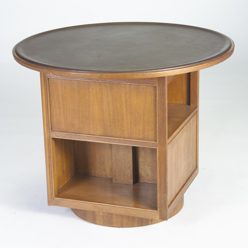 Appraisal: DUNBAR Revolving bookstand its circular top inset with dark brown