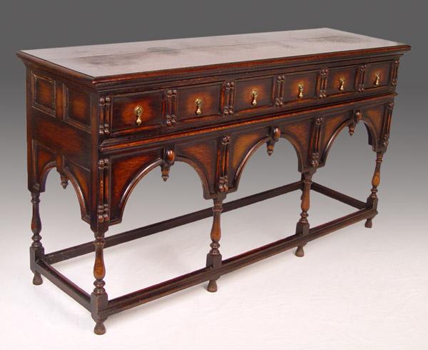 Appraisal: DARK OAK CARVED JACOBEAN SIDEBOARD molded drawers over architectural arches