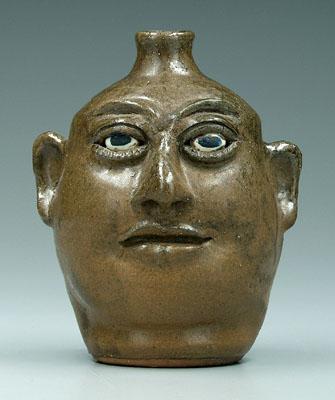 Appraisal: Lanier Meaders face jug White County Georgia - uneven olive