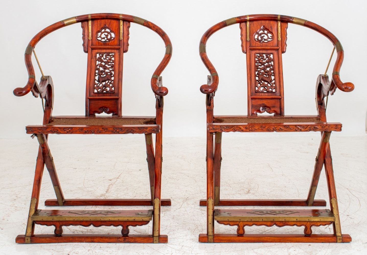 Appraisal: CHINESE BRASS-MOUNTED HONGMU FOLDING CHAIRS Chinese brass-mounted Hongmu wood Quanyi