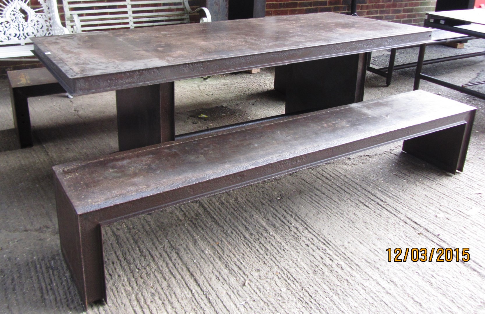 Appraisal: An industrial style steel rectangular table on slab end supports