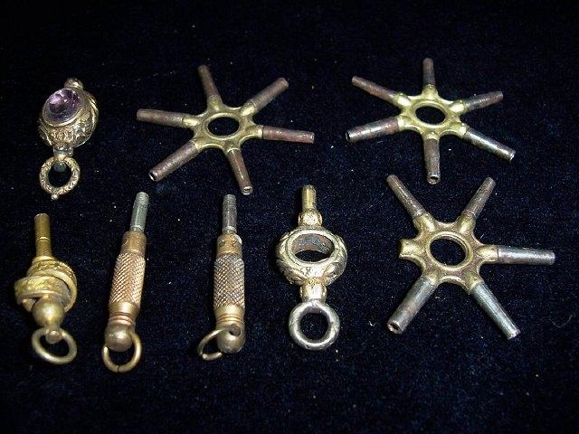 Appraisal: Three pocket watch key wheels and a few other pocket