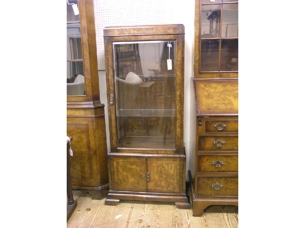 Appraisal: An Art Deco burr walnut display cabinet two plate glass