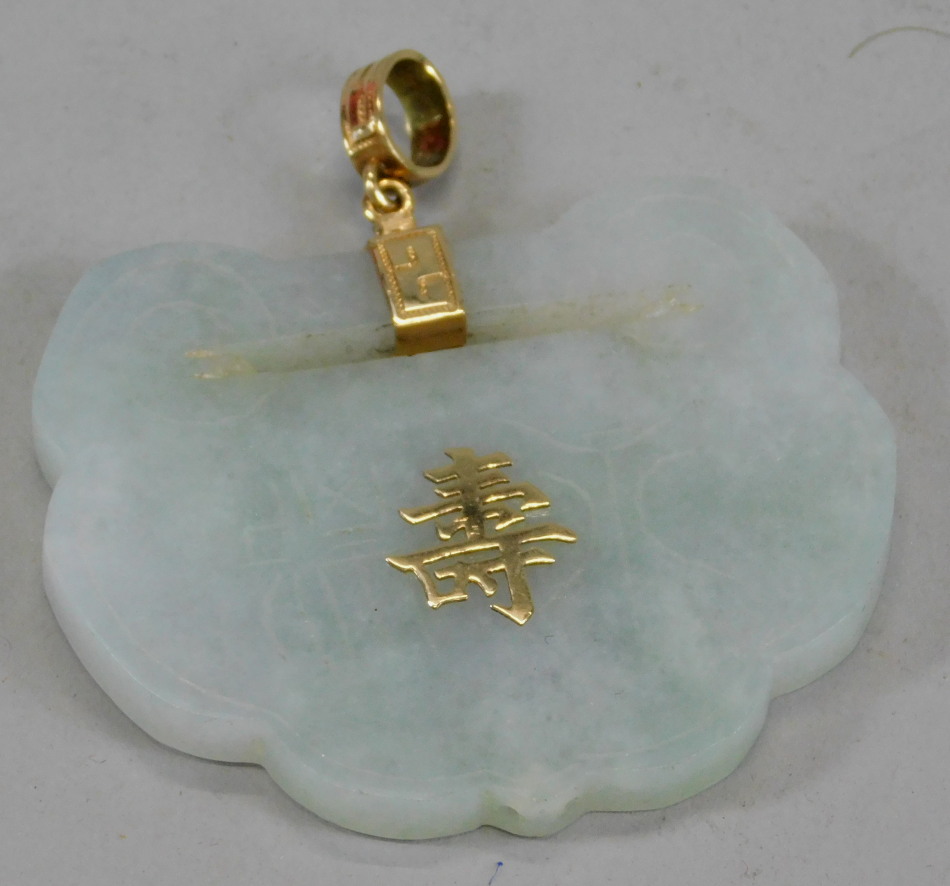 Appraisal: A modern jade pendant with Chinese writing and yellow metal