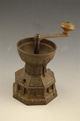 Appraisal: A cast iron coffee grinder modelled as York Minster font