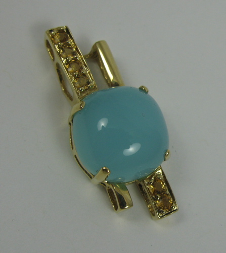 Appraisal: BLUE CHALCEDONY AND K GOLD PENDANT set with a blue