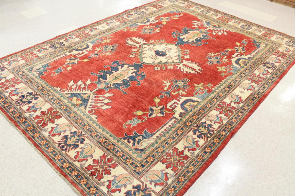 Appraisal: HAND KNOTTED ORIENTAL CARPET Pakistani Persian central geometric medallion and