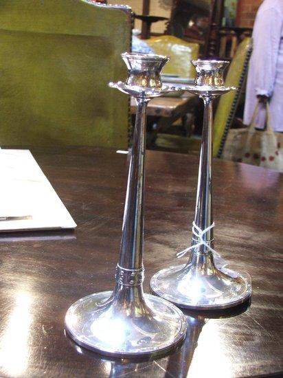 Appraisal: A PAIR OF ARTS AND CRAFTS STYLE CANDLESTICKS with plain