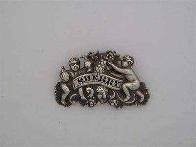 Appraisal: A Victorian cast Bacchandian wine label with putti pierced 'SHERRY'