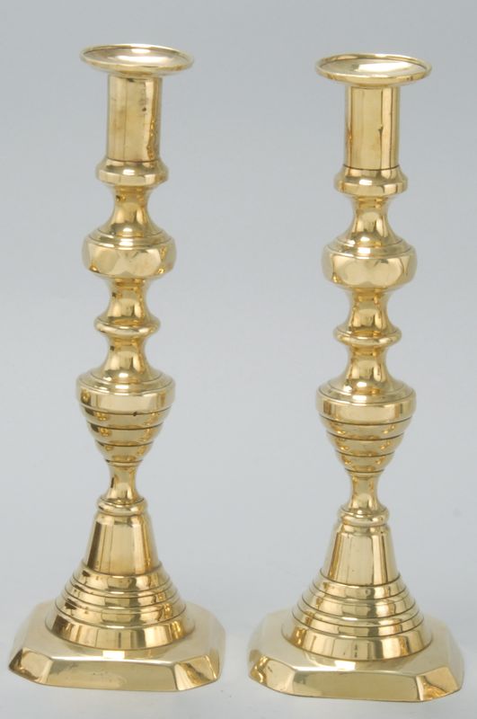 Appraisal: PAIR OF BRASS PUSH-UP CANDLESTICKS Mid- th CenturyIn bold beehive