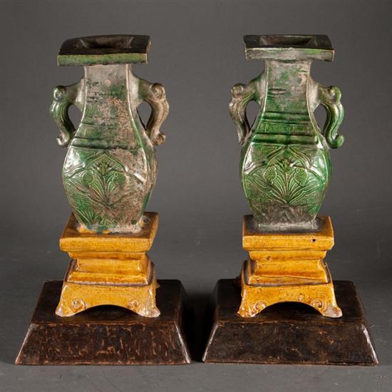 Appraisal: Pair of Chinese glazed terracotta urn on pedestal-form roof tiles