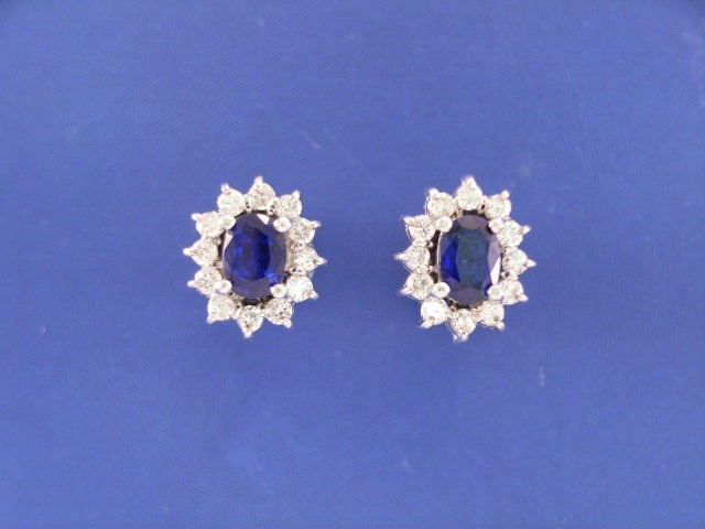 Appraisal: A pair of ct white gold sapphire and diamond cluster